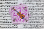 Pink 5-inch paper napkins with violin design and decorative musical pattern on sheet music