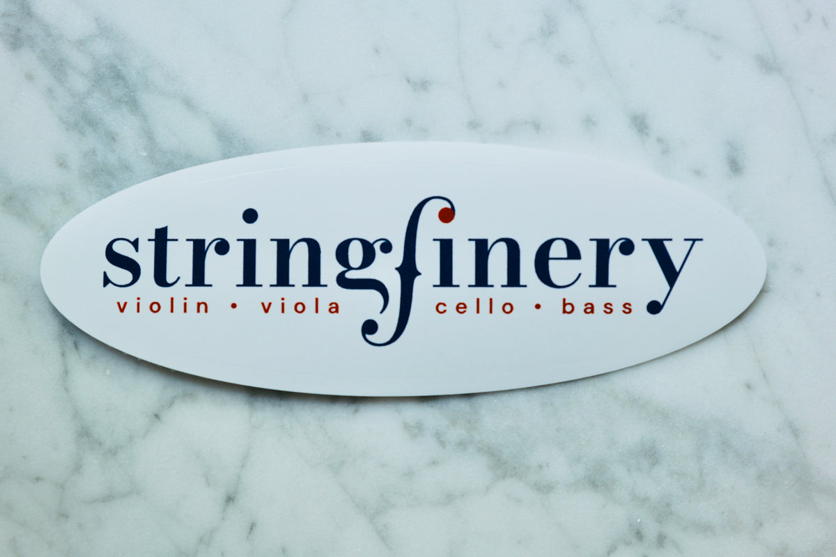 Stringfinery oval logo sticker on a light marble surface