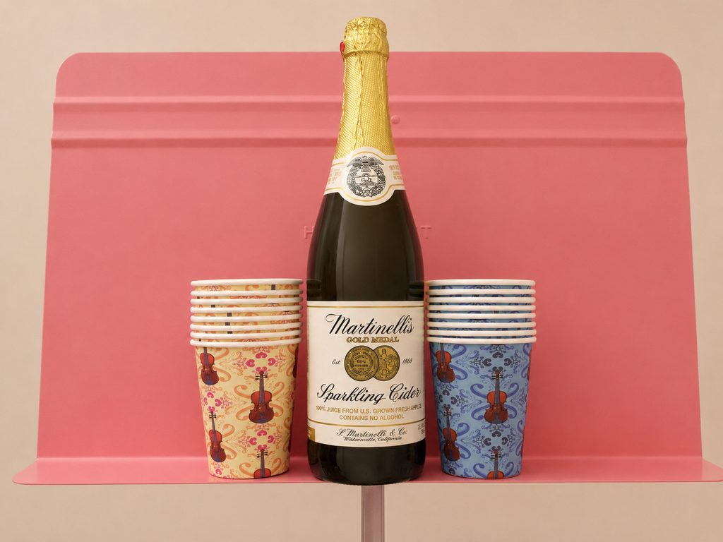 Dawn and blue 9 oz paper cups with repeating viola pattern with a sparkling cider bottle on a music stand