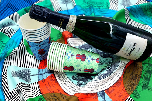 Blue and Eau de Nil 9 oz paper cups with repeating cello pattern with a champagne bottle on an intricate background